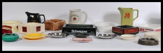 A group of vintage 20th century advertising point of sale pub breweriana ashtrays and whiskey jugs