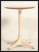 A mid century metal and formica lamp table in the manner of Eero Saarinen. Four pronged base with
