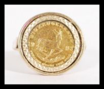 A gold 1/10 oz Krugerrand coin ring having a 1/10 1983 South African Krugerrand coin set in a 9ct