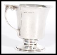 A silver hallmarked toddy cup, scroll handle raise