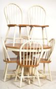 A contemporary circular pine and white painted extending dining table together with a set of 4