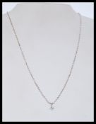 An 18ct white gold pendant necklace having a diamo