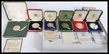 A group of silver proof coins to include Bristol 600 , John Pinches Prince Charles 1969 , Redland
