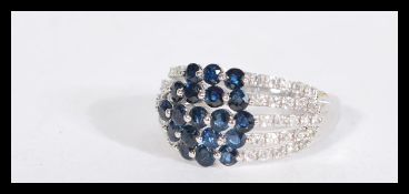 A 14ct white gold blue and white sapphire ring of