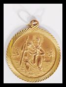 A hallmarked 9ct gold ST Christopher's pendant with necklace bail loop atop. Weighs 5.5 grams.