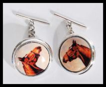 A pair of equestrian horse racing related sterling silver and enamel cufflinks cuff links having