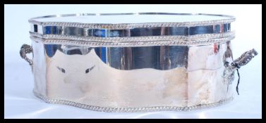 A large silver plated twin handled scalloped lidde
