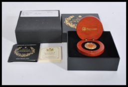 Australia Sovereign - A 2014 Australian Gold Proof Sovereign 22ct coin in capsule case within wooden