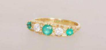 An 18ct gold emerald and diamond five stone ring h