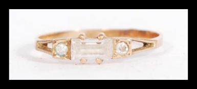 A 14ct gold ring having an emerald cut white stone