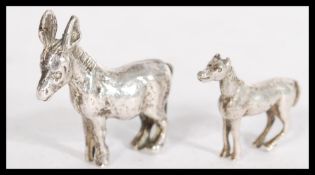 A silver miniature model figurine of a horse along