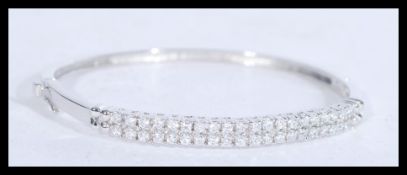 A sterling silver and CZ bangle bracelet having tw