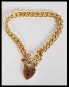 A hallmarked 9ct gold bracelet chain having a heart padlock clasp. Each link stamped. Weighs 26.5