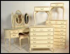 A Louis XV style french bedroom suite consisting of two tall chests , two bedsides and a triptych