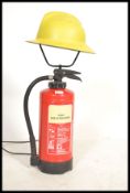 A 20th Century up-cycled fire extinguisher, converted in to a floor lamp surmounted with a