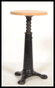 A vintage early 20th century Singer sewing machinist industrial stool raised on a quadruped cast