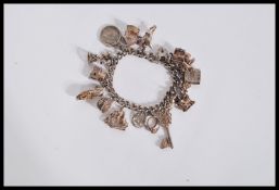 A silver charm bracelet having a hallmarked heart