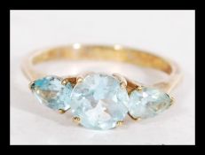 A hallmarked 9ct gold three stone blue topaz ring