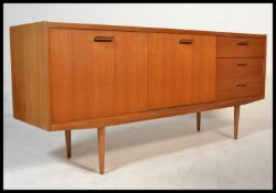 A vintage retro 20th century Danish influence sideboard raised on tapered supports having central