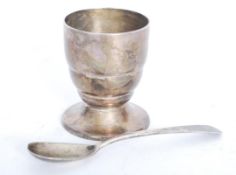 A matched silver eggcup and spoon consisting of a Georgian silver spoon with ribbed eggcup. Please
