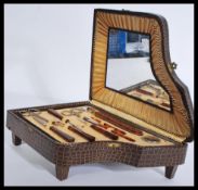 A fantastic 20th century faux crocodile vanity manicure set case in the form of a grand piano having