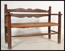 A country oak and rattan weave hall settle bench Raised on turned legs united by stretchers having a