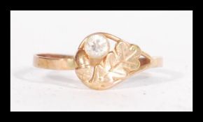 A 14ct gold ring having a leaf and acorn motif wit