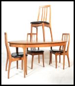 A vintage retro 20th century dinning table and chairs suite consisting of a teak extending table
