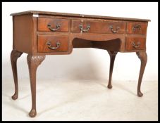 A 1950's Queen Anne revival mahogany writing desk