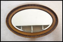 An early 20th century 1930's oval wall mirror havi