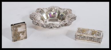 A sterling silver double pill box along with a silver white metal vesta case / pill case in the form