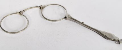 A pair of silver white metal lorgnettes having a c