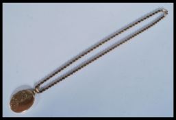 A 9kt gold rope twist necklace chain having a hallmarked 9ct gold locket pendant with chased