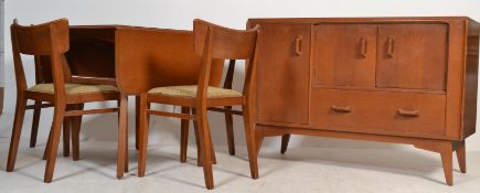 A mid century Ernest Gomme, circa 1950's golden oak dining room suite comprising sideboard, dining