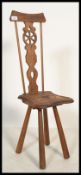 A 19th century Victorian arts and crafts carved oak spinning chair having a hand carved Lancaster