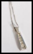 A hallmarked 9ct white gold and diamond pendant ne