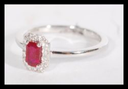 An 18ct white gold ruby and diamond ring having a