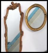 Two vintage mirrors one adorned with cherub masks and scrolled decoration and the other of simpler