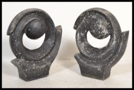 A collection of 20th century abstract garden sculptures of roundel form being made of composite