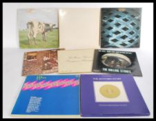 A collection of vinyl long play records featuring several artists to include The Beatles, Pink