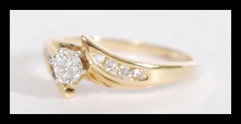 An 18ct gold and diamond ring having a central bri
