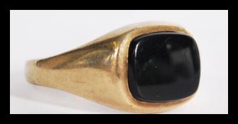 A hallmarked 9ct gold black onyx signet ring having inset stone in plain shank. Weighs 2.3 grams