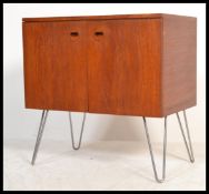 A vintage retro 20th century teak media cabinet sideboard of small proportions having twin