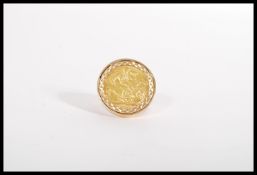 A 9ct gold early 20th century full sovereign ring having a 1904 Edwardian sovereign set in a