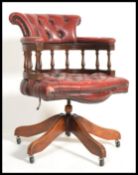 An antique style 20th century Ox blood buttoned back leather Captains style swivel desk office