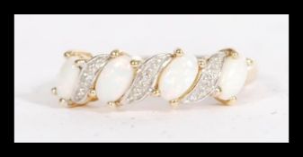 A hallmarked 9ct gold opal ring having opal panes spaced with illusion set diamonds. Size M.4.