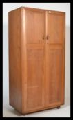 A stunning light beech and elm wood Ercol two door ' Windsor pattern ' wardrobe, fitted with twin