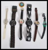 A group of vintage Swatch watches along with a pai
