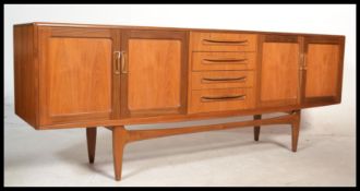 A good retro 1970's long and low G plan Fresco teak sideboard enclosed by moulded panelled door