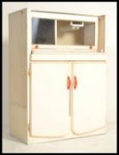 A vintage 20th century, circa 1950's  small proportion kitchen unit with red formica top.